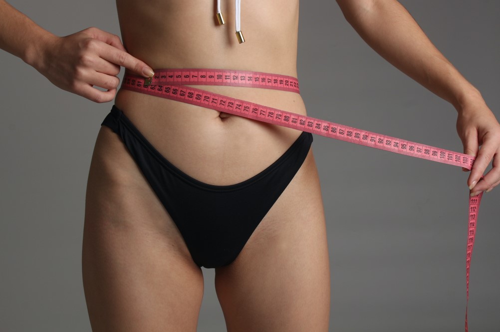 women measuring waistline